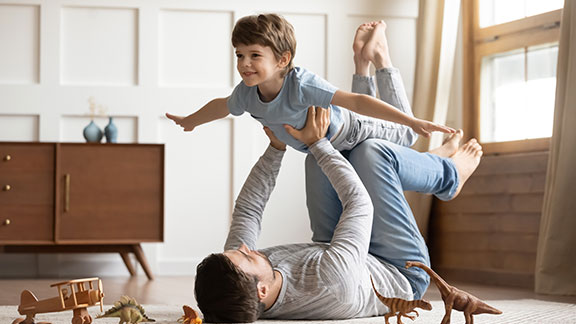 father and son playing at home